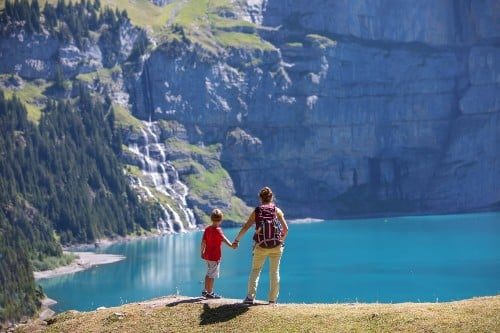 Mother with her son in the mountains in Switzerland on Lake Oeschinensee
