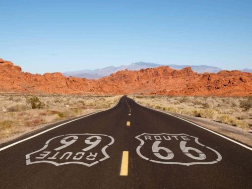 route-66-pavement-sign-with-mojave-desert-red-rock-mountainsjpg